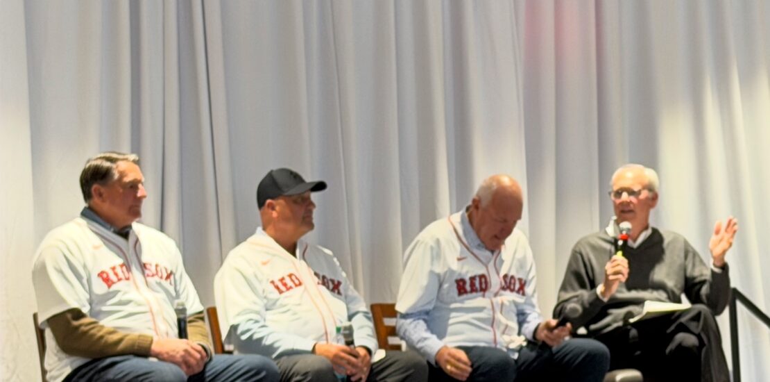 1986 Boston Red Sox players Bob Stanley, Bruce Hurst, and Spike Owen sharing stories on stage at a panel event