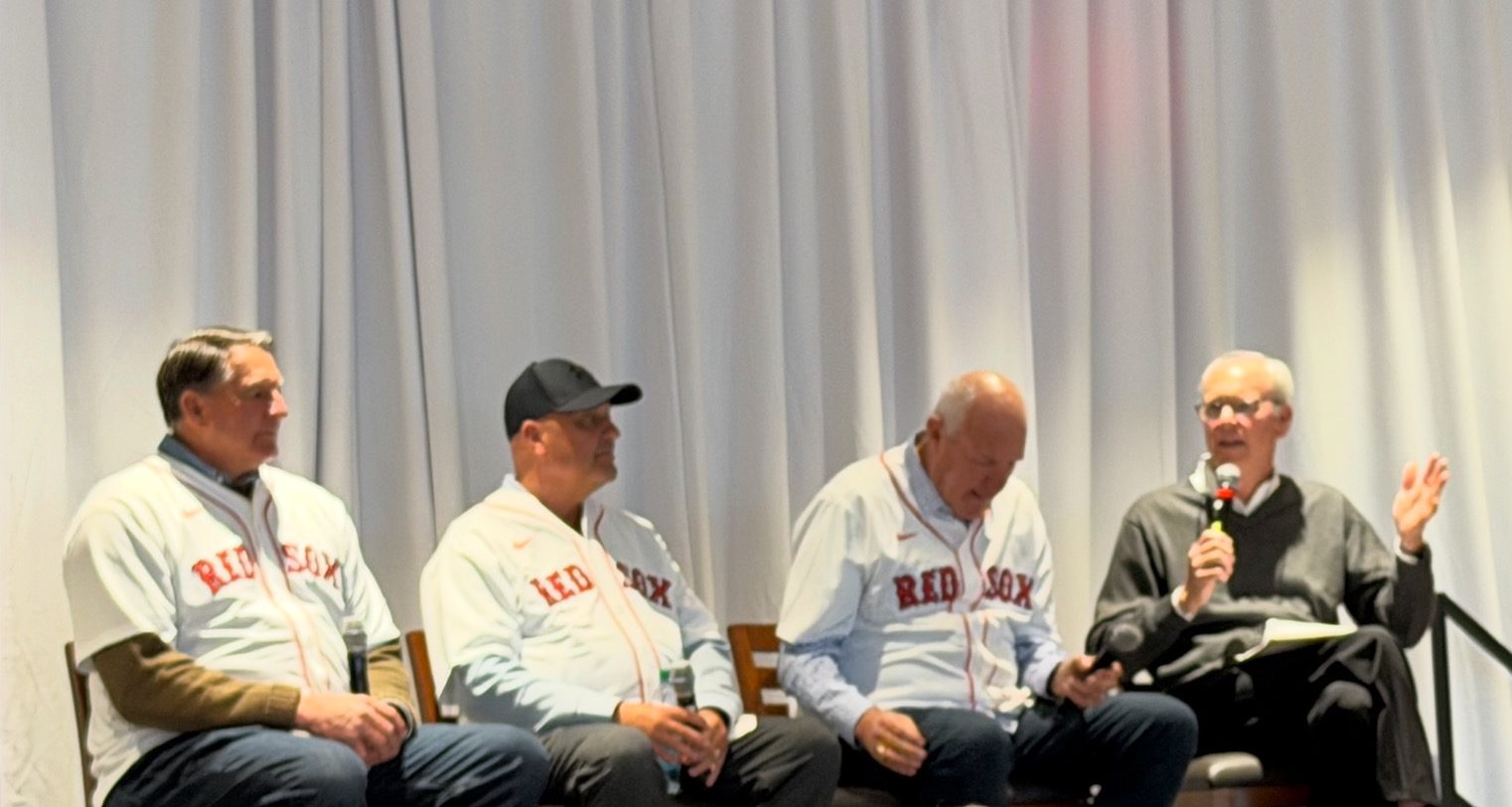 1986 Boston Red Sox players Bob Stanley, Bruce Hurst, and Spike Owen sharing stories on stage at a panel event